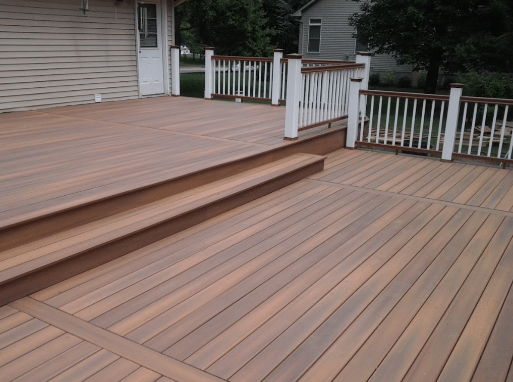 multi-level composite deck with white and brown railing