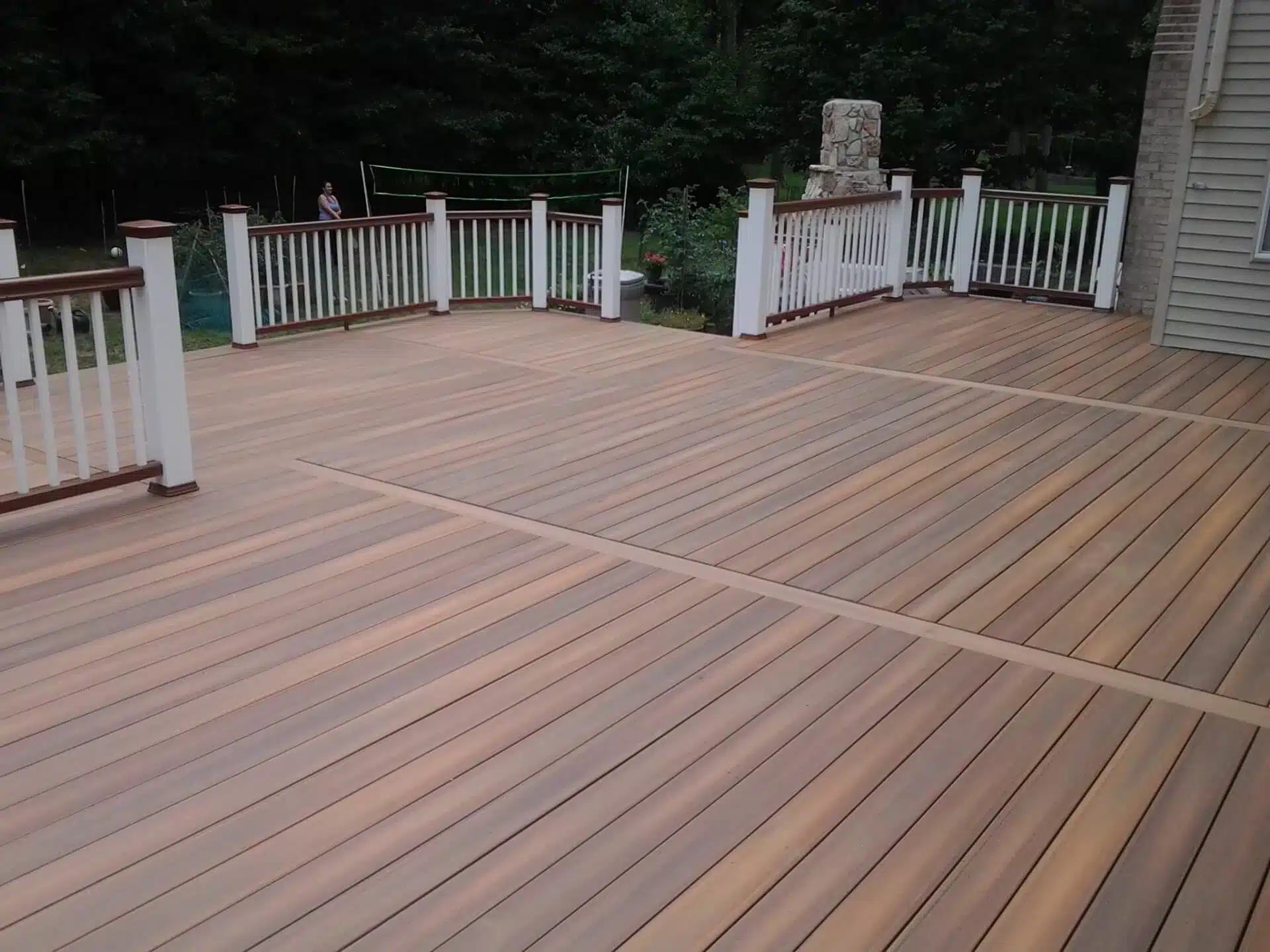 Composite deck with railing and brown post caps.