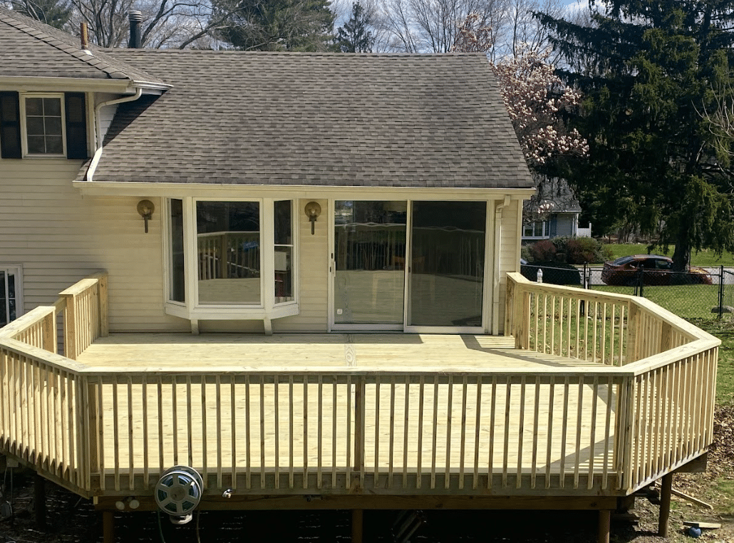 pressure-treated deck with railing - Decks Builders in New Jersey