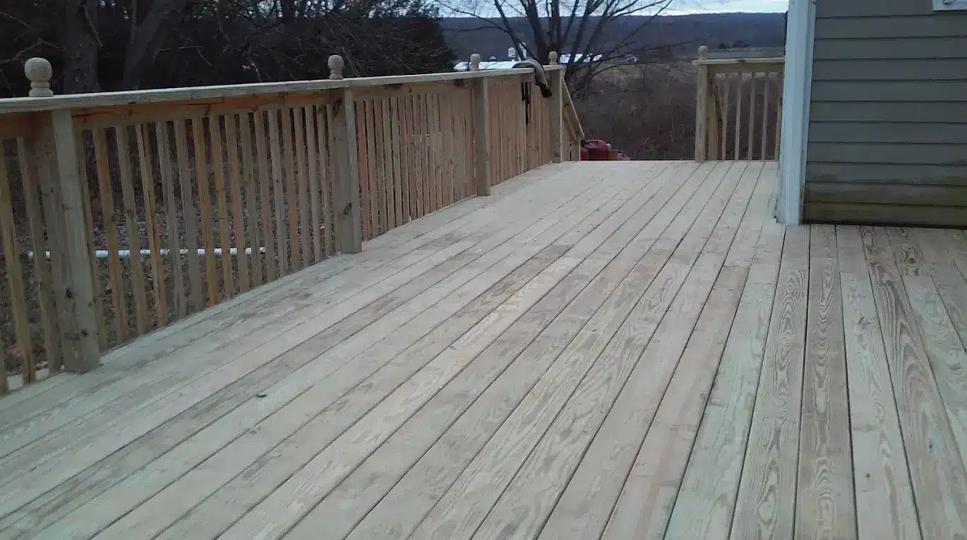 pressure-treated deck with wooden railing and deck posts