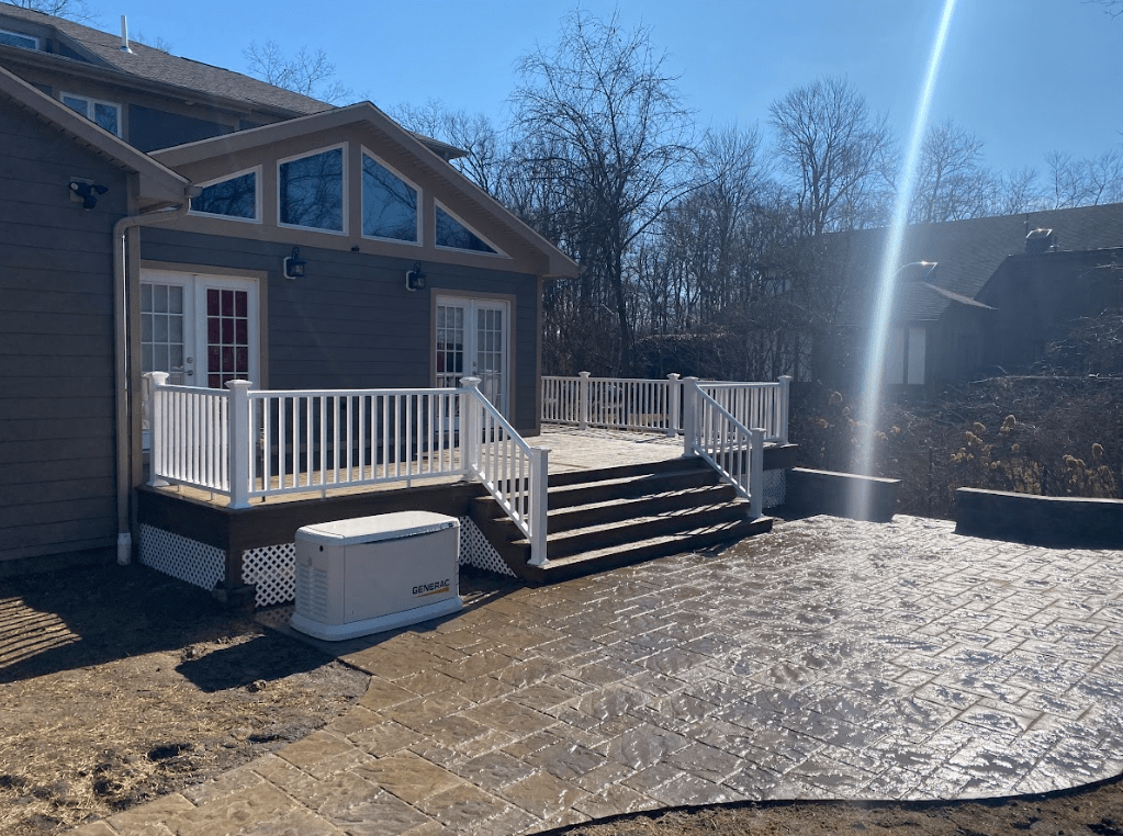 photo of a stamped concrete patio with custom deck for a post about patios - Patio Builder near me in New Jersey