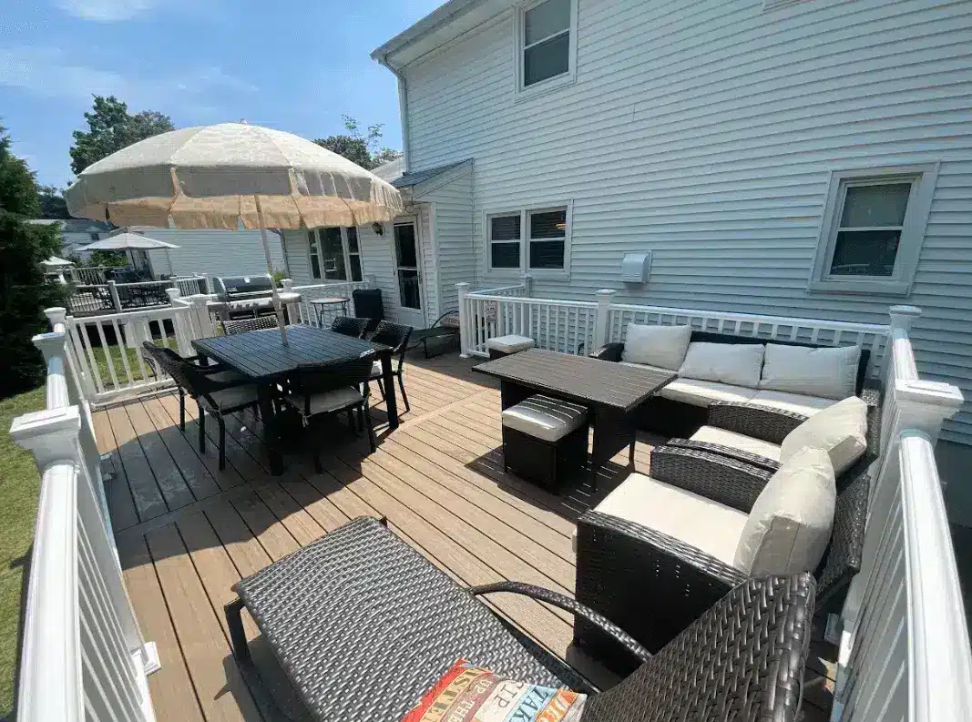 Composite deck with white railing and outdoor furniture - Custom Composite Deck builder and contractor - Montclair, New Jersey