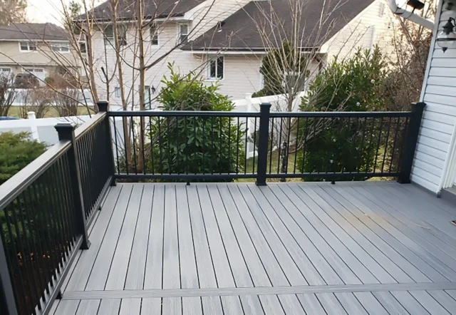 Gray composite deck with black railings.